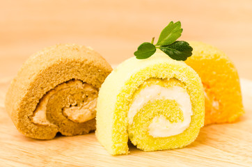 Roll cake on wooden background