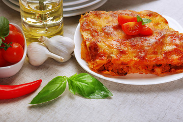 Portion of tasty lasagna on table