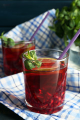 Pomegranate drink in glasses with mint and slices of lime