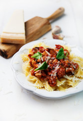 Farfalle pasta with chicken, tomato sauce and mushrooms