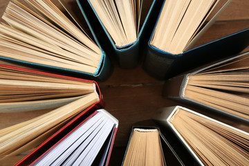 Naklejka premium Group of books on wooden planks background, top view