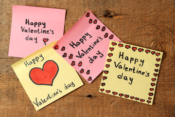 Valentines day notes on wooden background