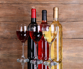Different wine on table on wooden background