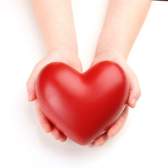 Heart in child hands isolated on white