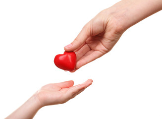 Heart in child and mother hands isolated on white