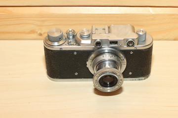 Vintage camera on a wooden background.