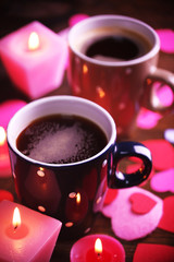 Two cups on table with candles and decor close-up