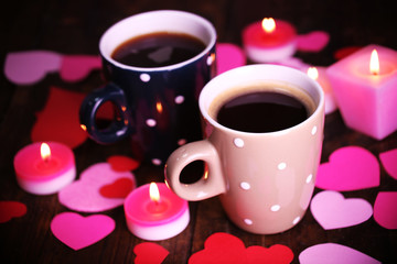 Two cups on table with candles and decor close-up