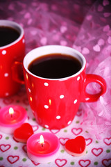 Two cups on table with candles and decor close-up