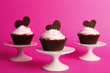 Delicious Valentine Day cupcakes on pink background