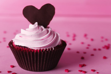 Delicious Valentine Day cupcake on pink background