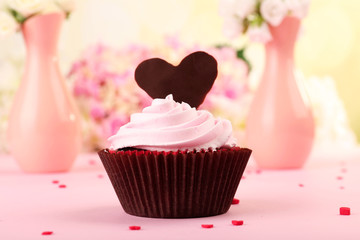 Delicious Valentine Day cupcake on pink background