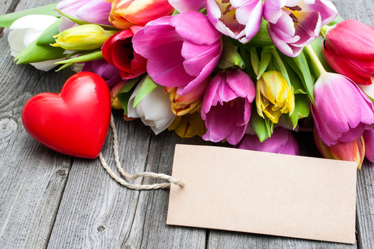 Bouquet of tulips with an empty tag and red heart