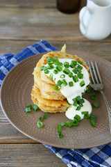 Fried potato pancakes with sour cream