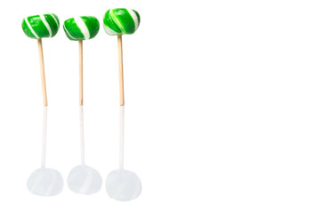 Green swirl peppermint candies over white background