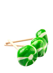 Green swirl peppermint candies over white background