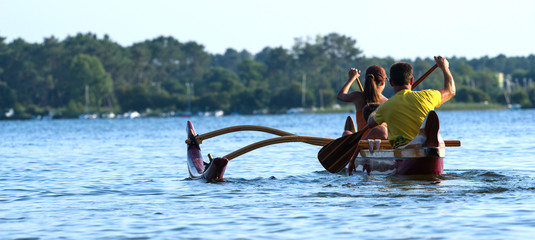 Couple making canoe kayak on a lake - obrazy, fototapety, plakaty