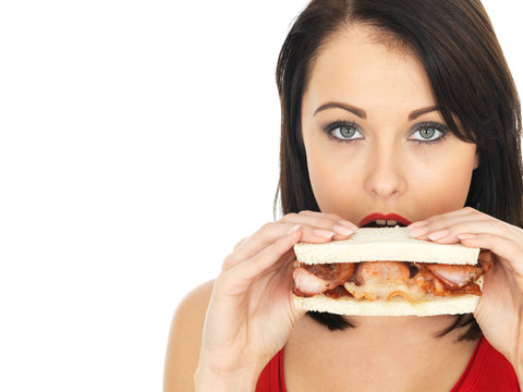 Young Woman Eating A Bacon Sandwich