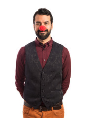 Man wearing waistcoat with clown nose