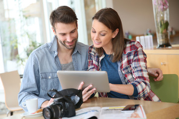 Photography students working together in coffee shop