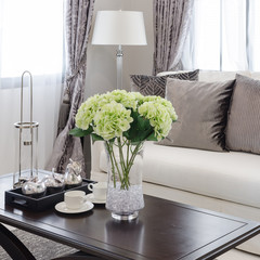 plants in glass vase on wooden table in living room