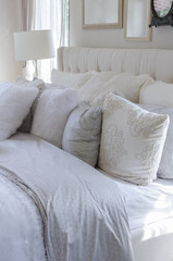 white and grey pillows on bed