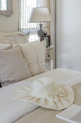 Fototapeta na wymiar white hat on luxury bed in bedroom