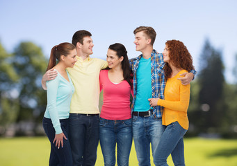 group of smiling teenagers over green park