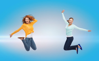 Fototapeta na wymiar smiling young women jumping in air