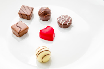 Heart shaped chocolate with other confectionery around