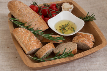 Bread with olive oil ,rosemary on the wooden plate