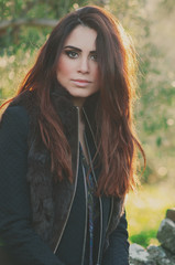 Fototapeta premium Beautiful young woman walking in the park, selective focus
