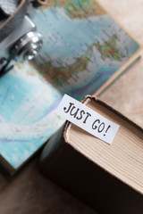 "Just go" book and map. Travel  concept.