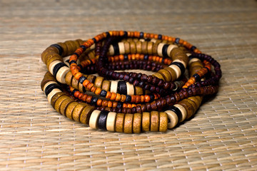 wooden bracelets in ethnic style on a straw mat