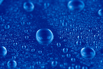 Drops of water on blue background - 77097948