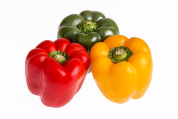 Red, green and yellow pepper on a white background
