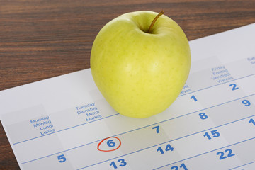 Apple On Calendar Marked With Marker