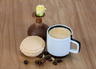 Fototapeta na wymiar Coffee with macaroons and rose