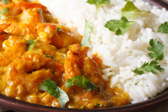 Shrimps in curry sauce with rice and cilantro macro horizontal