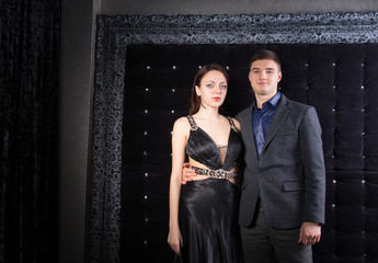 Young Couple in Elegant Outfits Looking at Camera