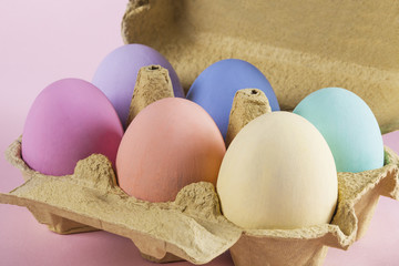 Colorful Easter eggs in egg carton closeup