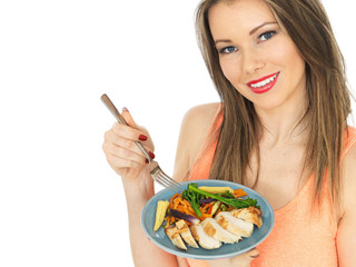 Young Woman Eating Chicken with Mixed Vegetables