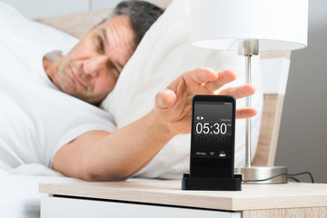 Man On Bed With Cell Phone
