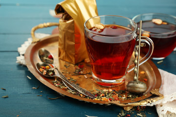 Beautiful vintage composition with herbal tea, on wooden table