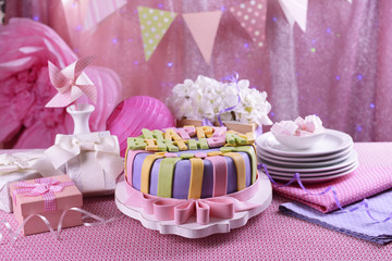 Delicious birthday cake on table on bright background