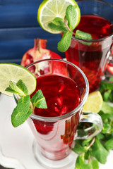 Pomegranate drink in glasses with mint and slices of lime