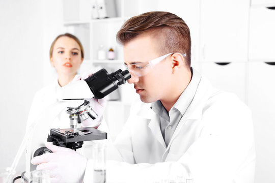 Young researcher carrying out scientific research in lab