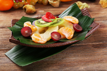 Fruit dessert on green leaf on table