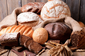 Different bread on table on wooden background