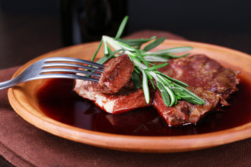 Grilled steak in wine sauce with bottle of wine